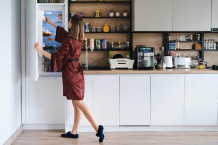 hungry-woman-looking-food-fridge-home-dont-have-much-there-white-kitchen-furniture-home-wear-red-silk-robe (1)