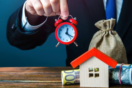 realtor-holding-clock-house-limited-offer-rental-business-special-offers-buying-home-making-mortgage-loan-seasonal-sale-investment-housing-with-further-profitable-rental (1)